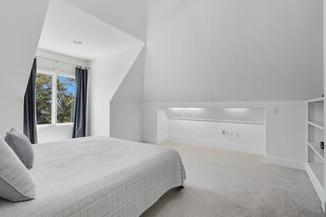 a bedroom with a large bed and a large window