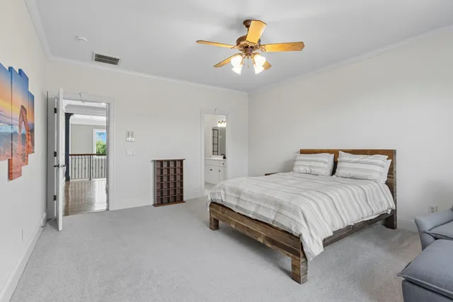 a spacious bedroom with a bed and a chandelier