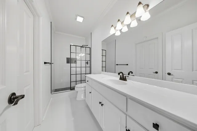 a bathroom with a sink a large mirror and shower