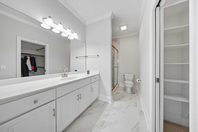 a spacious bathroom with a double vanity sink mirror and toilet