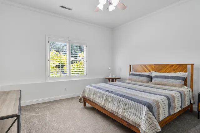 a bedroom with a bed and a window
