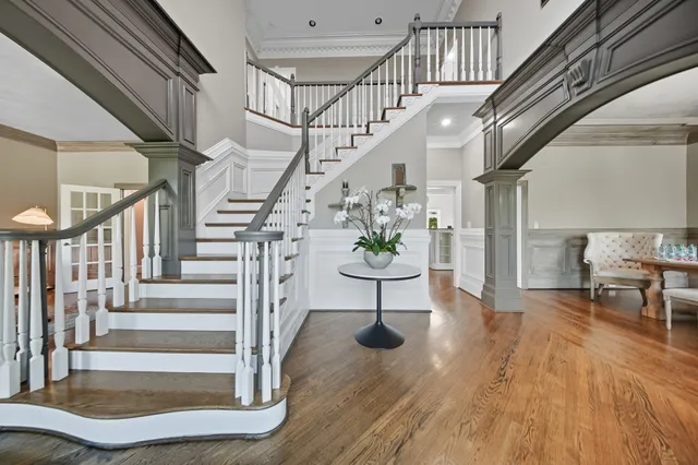 a view of entryway and hall with wooden floor