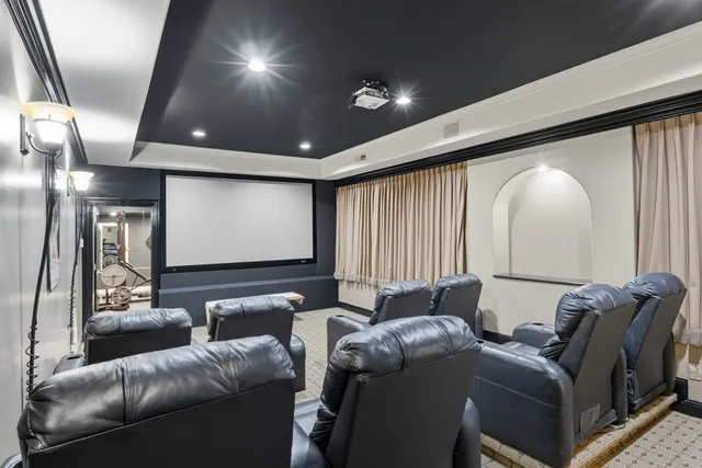 a media room with lots of chairs and a projector screen