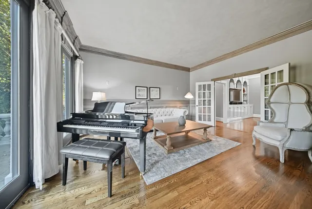 a living room with furniture and a piano