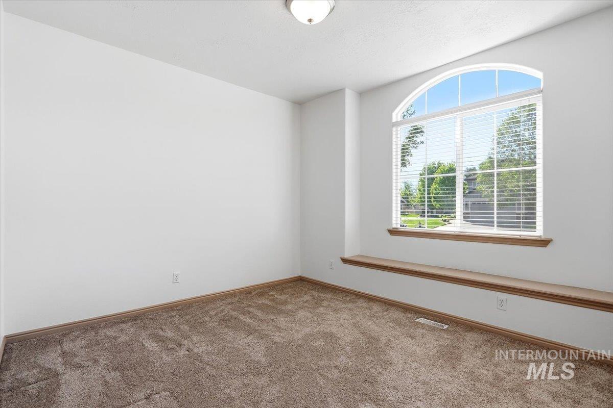 1183 North Buffalo Way Middleton, ID 83644 - Photo 27 of 47 Arched window featuring blinds, a built-in window ledge, and light brown carpeting