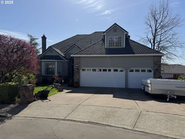 a front view of a house with a garden and pathway