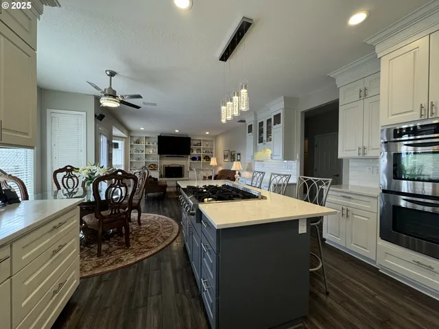 a view of a dining room with furniture a chandelier and wooden floor