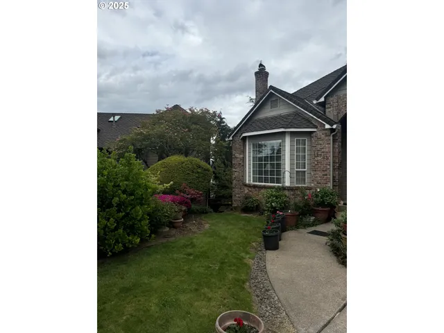 a view of a hallway with a dining table and chairs