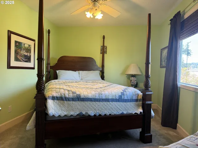 a bedroom with a bed dresser and a window