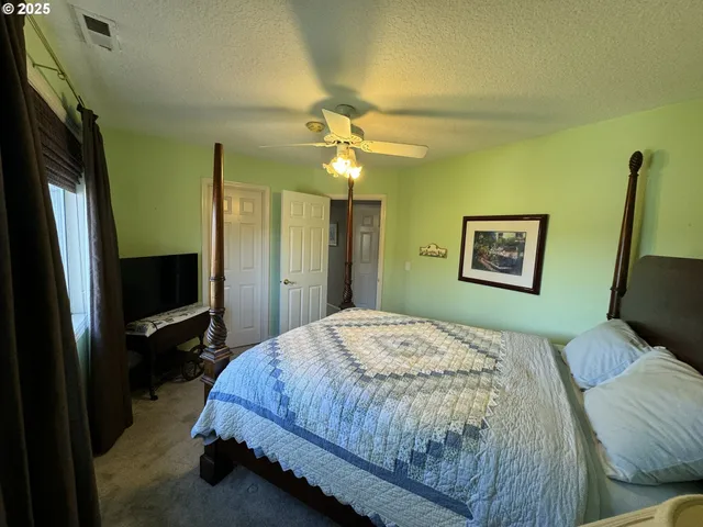 a bedroom with a bed and a large mirror