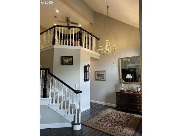 a view of a livingroom with furniture a dinning room and wooden floor