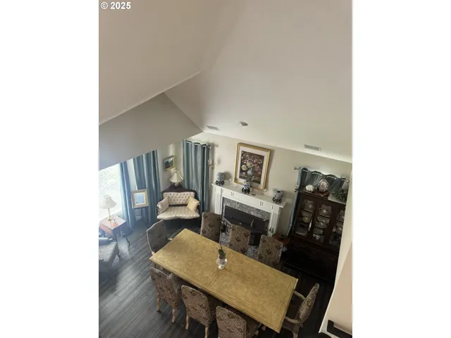 a view of a dining room with furniture and a chandelier