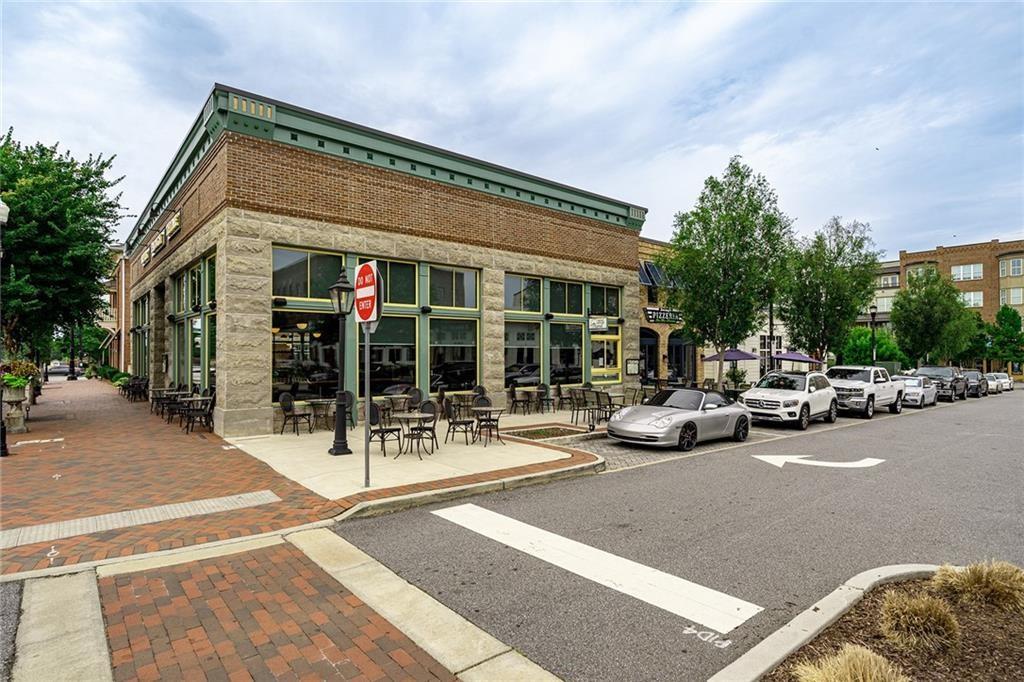 135 Alcovy Terrace Alpharetta, GA 30009 - Photo 37 of 56 a view of a patio with a table and chairs and potted plants