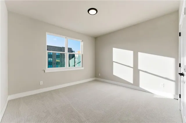 an empty room with windows and air conditioner