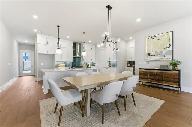 a large kitchen with a table and chairs