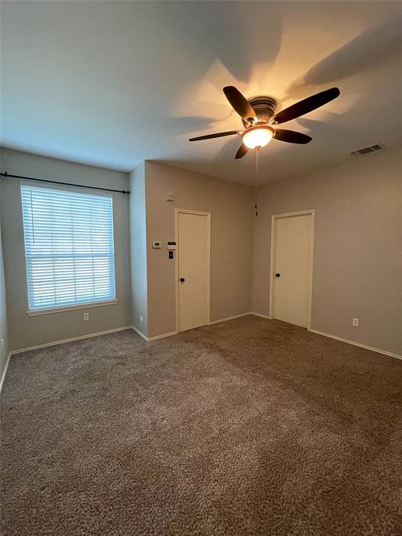 2917 Roxboro Road Euless, TX 76039 - Photo 13 of 20 a view of an empty room with a ceiling fan and window