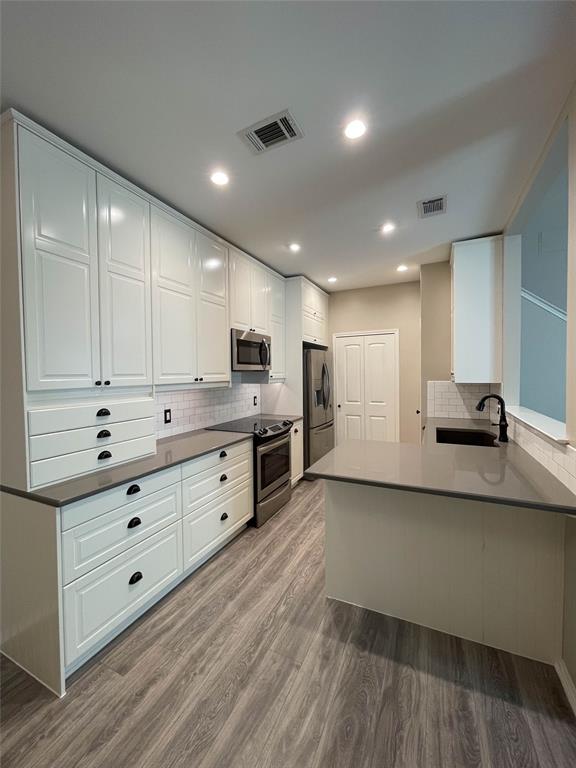 2917 Roxboro Road Euless, TX 76039 - Photo 7 of 20 a kitchen with stainless steel appliances kitchen island granite countertop a stove and a refrigerator