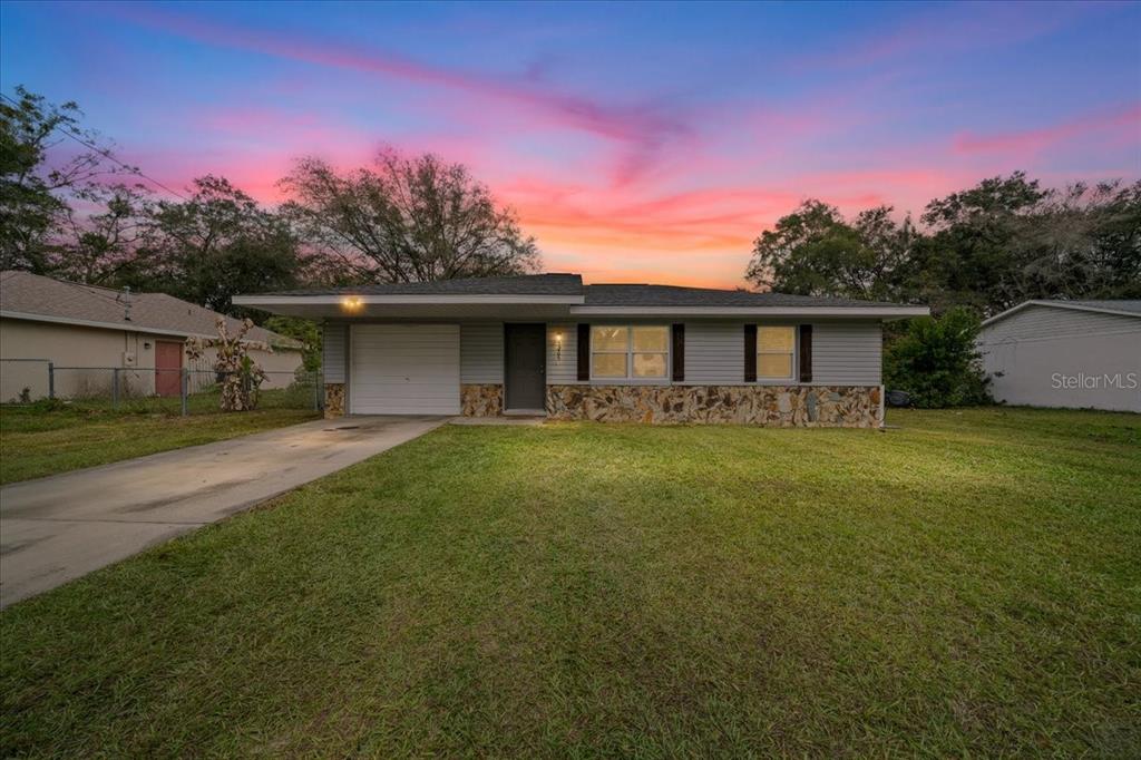 5265 Southeast 103rd Street Belleview, FL 34420 - Photo 1 of 1 a front view of a house with yard and green space