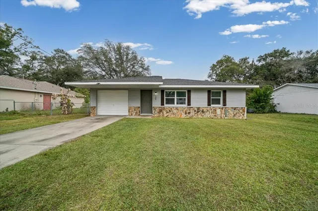 a front view of house with yard and green space