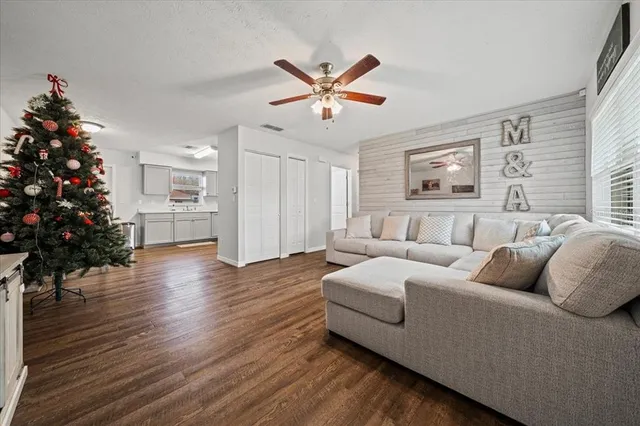 a living room with furniture ceiling fan and a window