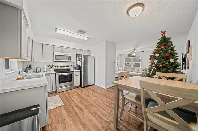 a kitchen with white cabinets and stainless steel appliances