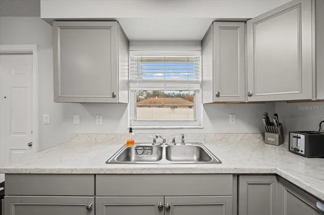 a kitchen with appliances cabinets and a sink