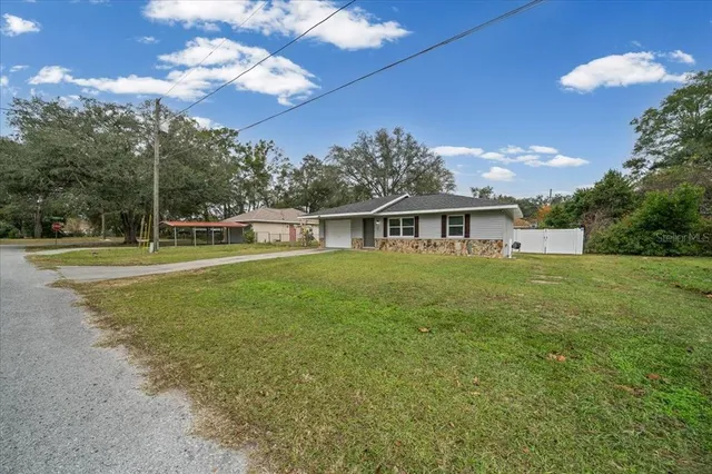 a view of house with outdoor space and yard