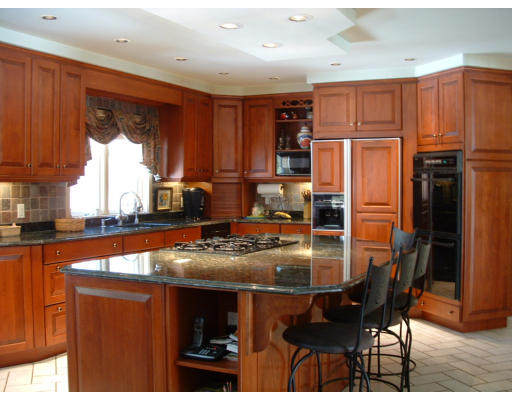 72 Hutchinson Road Sutton, MA 01590 - Photo 5 of 20 a kitchen with stainless steel appliances granite countertop a refrigerator a sink a stove a dining table and chairs