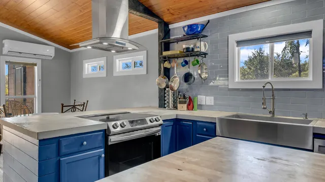 a kitchen with stainless steel appliances granite countertop a sink stove and cabinets