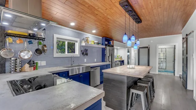 a kitchen with cabinets and wooden floor