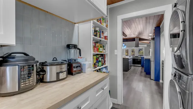a kitchen with a refrigerator and a stove top oven