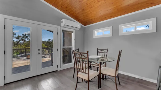 a dining room with furniture and wooden floor
