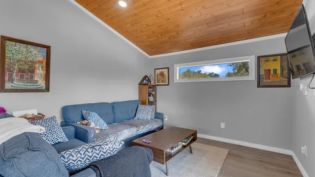 a living room with furniture and painting on the wall