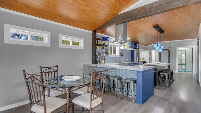 a view of a dining room with furniture and wooden floor