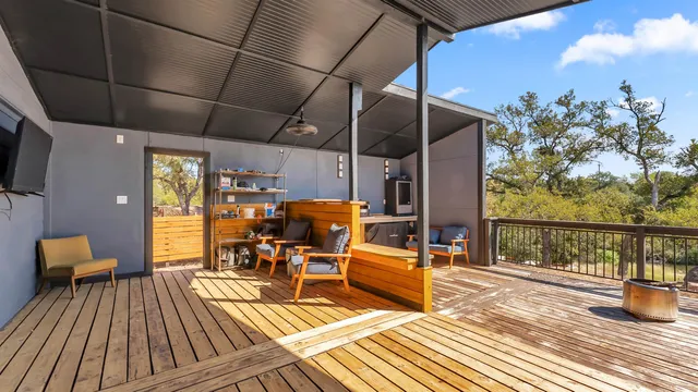 a view of a balcony with chairs and wooden floor