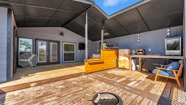 a view of balcony with wooden floor and outdoor seating