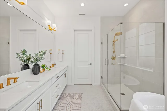 a bathroom with a granite countertop sink a toilet and shower