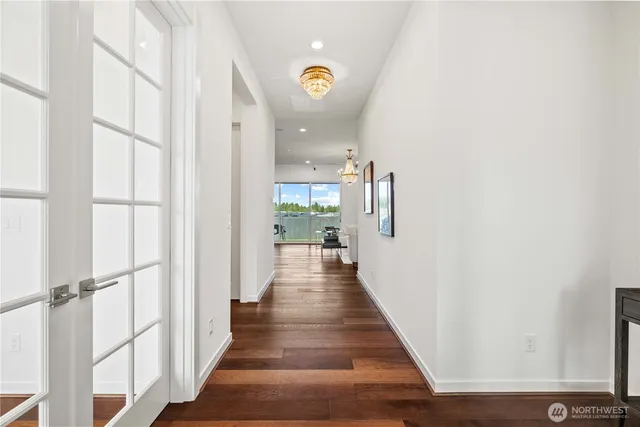 a view of a hallway with wooden floor