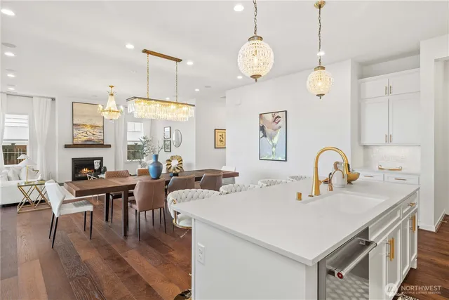 a view of kitchen and dining area with furniture wooden floor and chandelier
