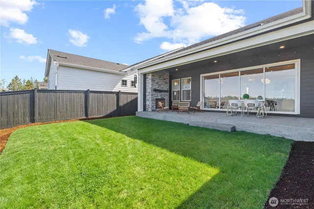 a view of a house with a yard and sitting area