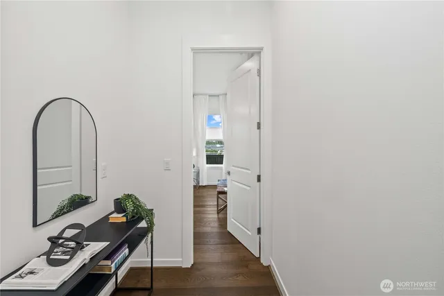 a view of a hallway with workspace and a mirror