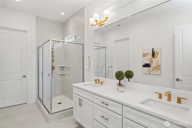 a bathroom with a shower sink and mirror