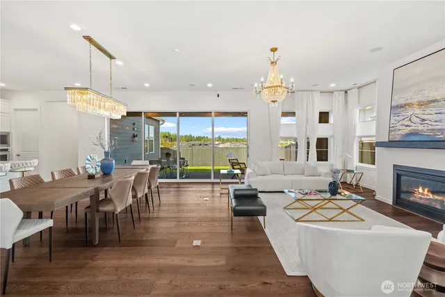 a living room with fireplace furniture and a chandelier