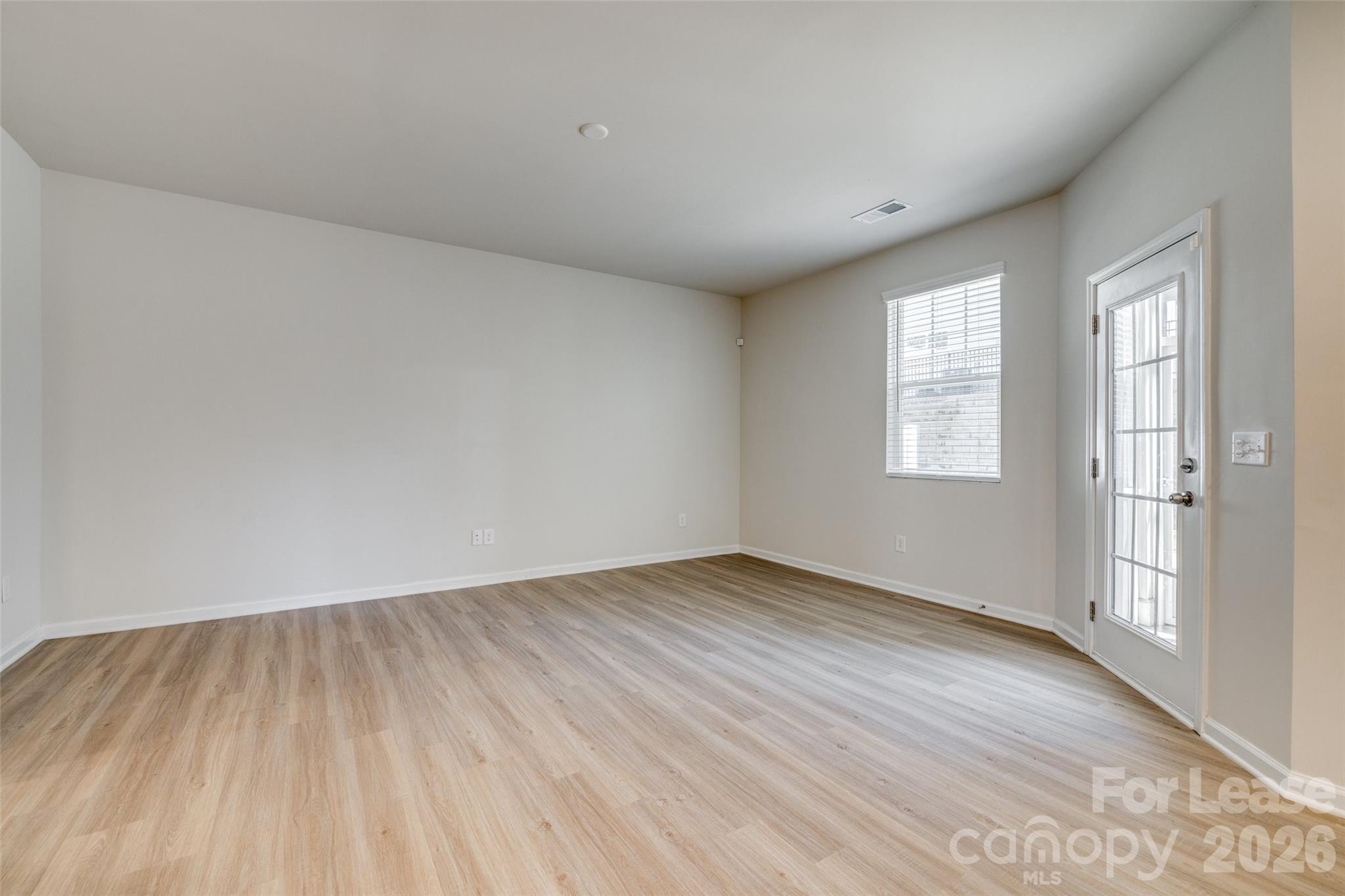 807 Gable Oak Lane Fort Mill, SC 29708 - Photo 11 of 39 an empty room with wooden floor and windows
