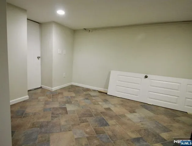 a view of a room with an empty space and a window