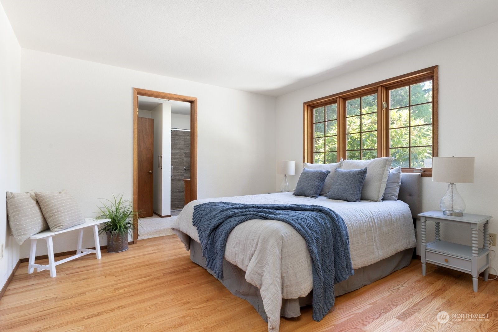 3550 Swede Hill Road Clinton, WA 98236 - Photo 15 of 40 a spacious bedroom with a bed and wooden floor