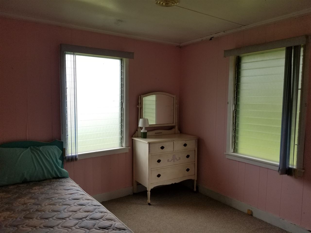 2165 Kokomo Road Haiku, HI 96708 - Photo 5 of 12 a view of a bedroom with window and cabinet