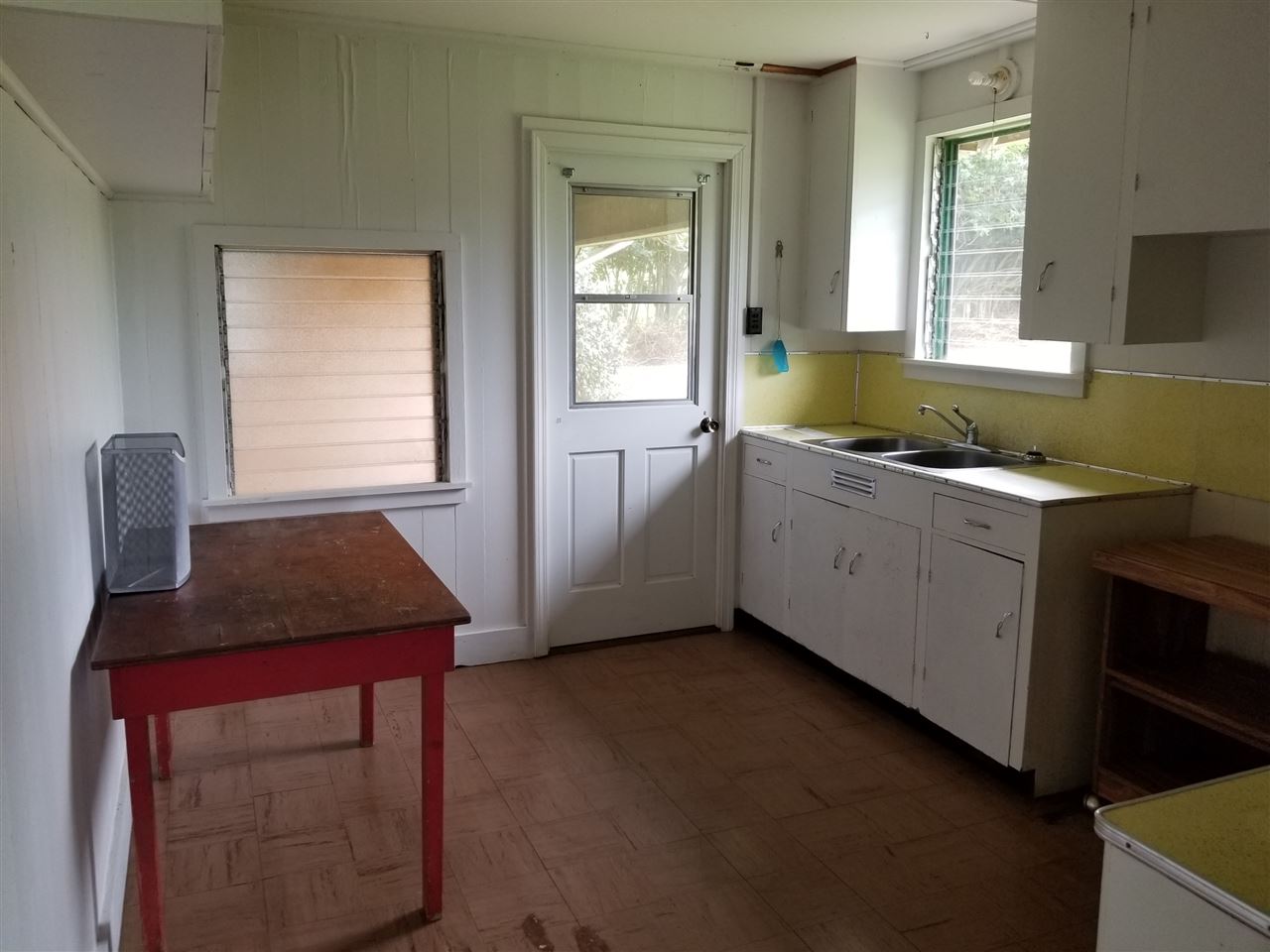 2165 Kokomo Road Haiku, HI 96708 - Photo 6 of 12 a kitchen with a stove a sink and a window