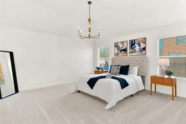 a spacious bedroom with a bed and a window