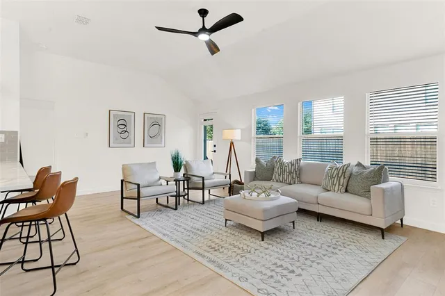a living room with furniture and a large window